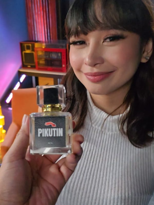 Creator holding a Pikutin bottle